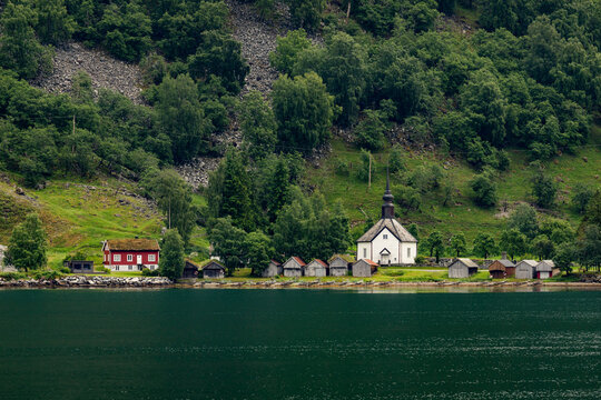 A beautiful summer  landscape with a village buildings by the fjord . A summer scenery of World Heritage Area in Western Norway.
