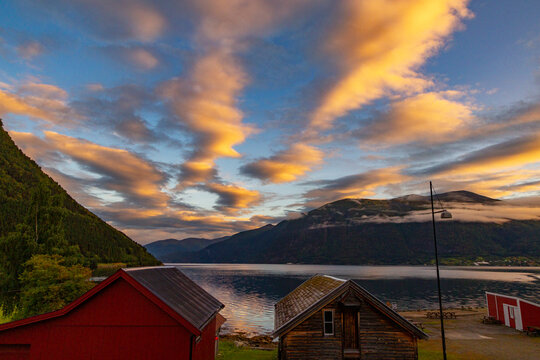 A beautiful summer  landscape with a village buildings by the fjord . A summer scenery of World Heritage Area in Western Norway.
