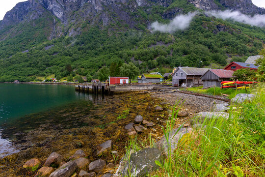 A beautiful summer  landscape with a village buildings by the fjord . A summer scenery of World Heritage Area in Western Norway.