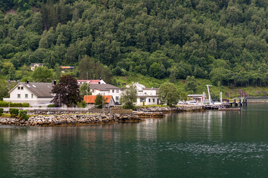 A beautiful summer  landscape with a village buildings by the fjord . A summer scenery of World Heritage Area in Western Norway.