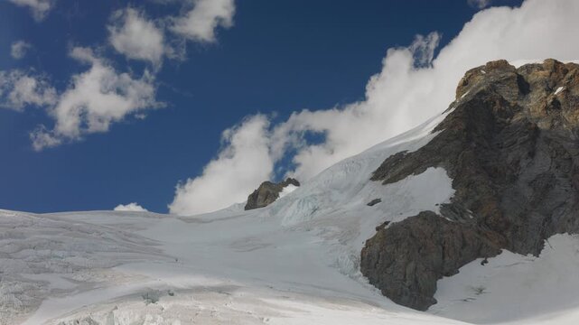 Clouds rolling over mountain peaks in Monte Rosa Italian alps