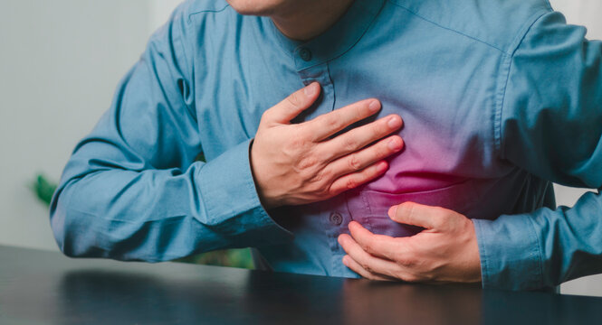 Person holding the chest illustrate cardiovascular symptoms and heart health concerns. Represents medical care, prevention, diagnosis, wellness, health awareness, and risk.