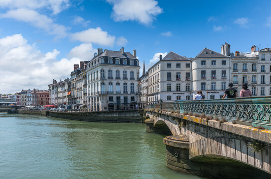 Bayonne, France &ndash; July 28, 2026: Tourists arriving in the city's Old Town by crossing the Saint-Esprit Bridge, situated over the confluence of the Nive and Adour rivers.