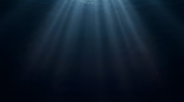 Underwater light rays piercing through deep blue ocean water surface background