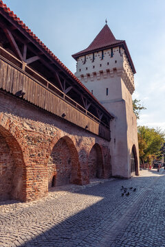 Potters Tower rising above the brick defensive wall on Cetatii Street in Sibiu, Transylvania, Romania