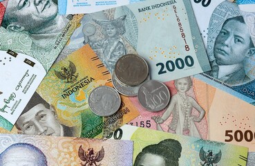Indonesian rupiah money banknotes and coins on table. Indonesia cash bills of IDR currency © Viktor