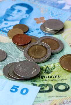 Thai baht money banknotes and coins on table. Thailand cash bills of THB currency