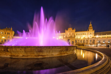 Night view of illuminated purple fountain at Plaza de Espana © Dmitry Rukhlenko