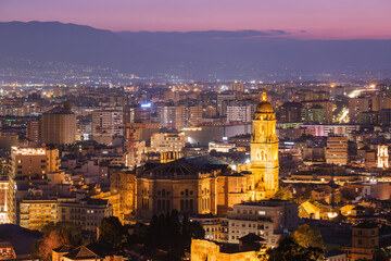 Fototapeta premium Twilight aerial view of illuminated Malaga Cathedral and city