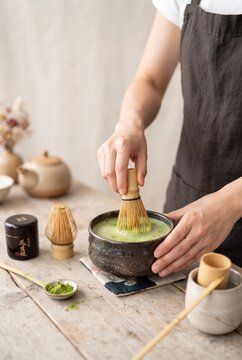 Hand whisking matcha tea, traditional preparation