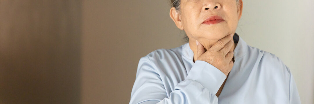 Senior, late adult old Asian female suffering from cough and sore throat, indoors scene, health care and wellness concept image, closeup shot
