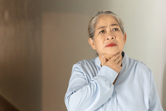 Senior, late adult old Asian female suffering from cough and sore throat, indoors scene, health care and wellness concept image