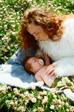 Mother and baby resting in a field of flowers