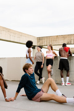 Sports club members relaxing together in a sunny city park