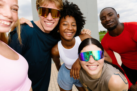 Portrait of a group of runner friends, happily posing together