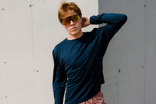 Medium shot portrait of an athletic young man, wearing running glasses