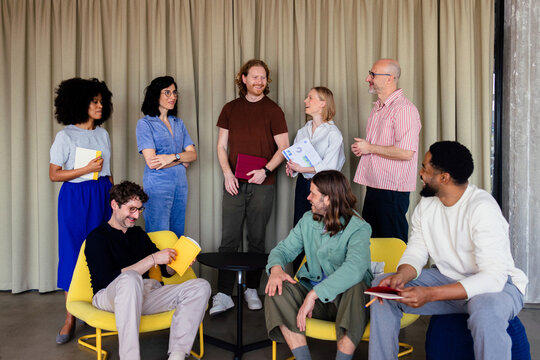 Casual Office Team Meeting With Smiling Colleagues