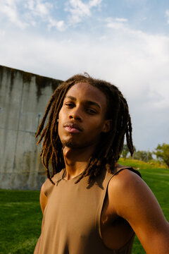 Medium shot portrait of a professional athlete posing in a public park