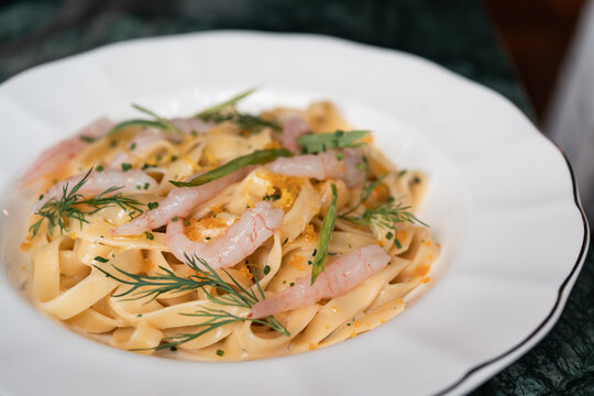 Dish of Pasta With Shrimp Served on a White Plate