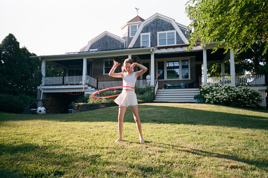 Young Girl with hula hoop in backyard film 