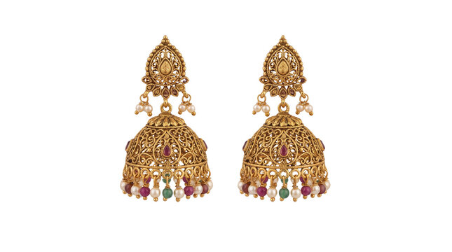 Pair of Indian traditional gold jhumka earrings with intricate handwork, pearls, and colorful gemstones isolated on white background