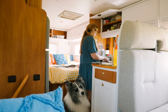 Woman Cooking in a Camper Van