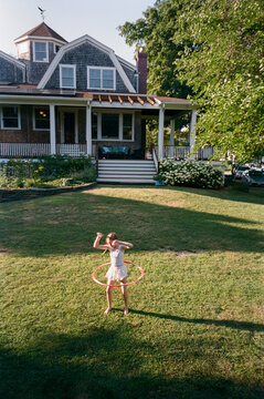 Young Girl with hula hoop in backyard of home film