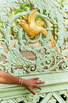 Decorative Wooden Railing With Bird and Hand in Garden