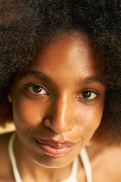 Smiling Woman With Curly Hair Looking at the Camera