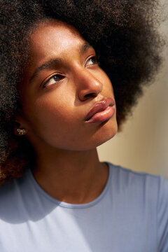 Woman With Curly Hair Looking up on a Sunny Day