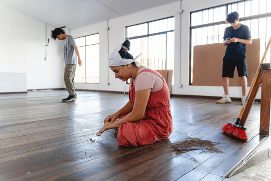 Team stripping old flooring during renovation project