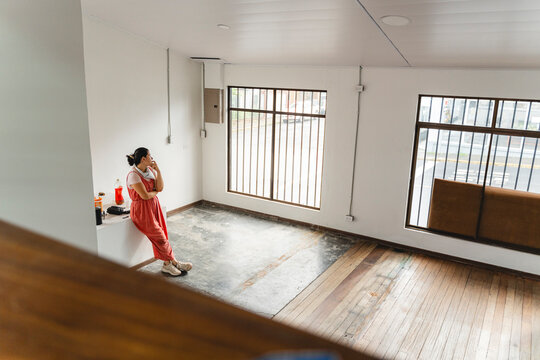 Individual contemplating future in empty apartment or office space
