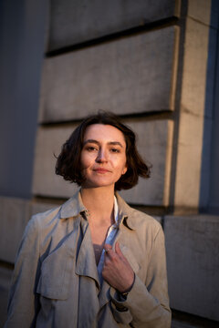 Portrait of a Woman Standing Near a Stone Wall During Sunset