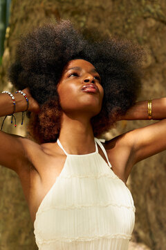 Portrait of a Woman With Curly Hair in a Sunny Outdoor Setting