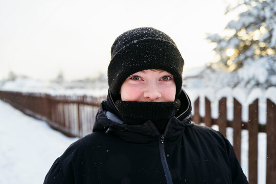Smiling in Winter Wonderland With Snowflakes Dancing Around