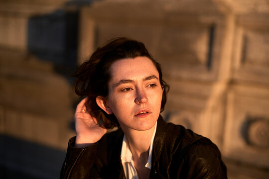Young Person Sitting Outdoors in the Evening Light
