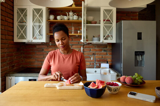 Woman chops grapefruit
