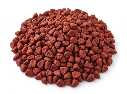 Heap of dry organic annatto seeds isolated on white background, widely used as achiote spice and natural food coloring agent for traditional culinary recipes