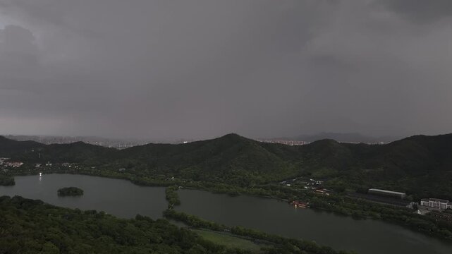 dark storm clouds looming over lake and mountain landscape