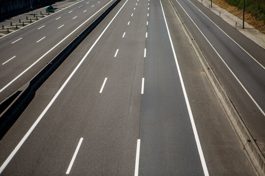 Empty highway with clear lanes and no vehicles in sight during daytime
