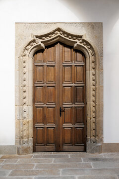 Wooden door with ornate stone framing in historic building