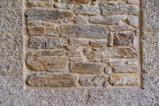 Stone wall texture with various rock shapes and colors in a historical building