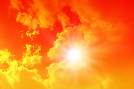 Hot sun in the orange sky, sunny weather and extreme temperature background