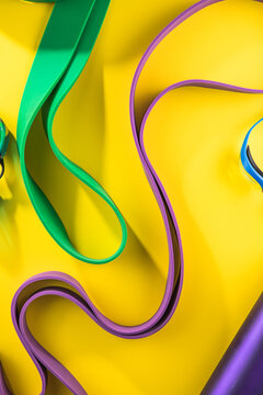 Set of sports swim  accessories, fitness bands on yellow background top view.