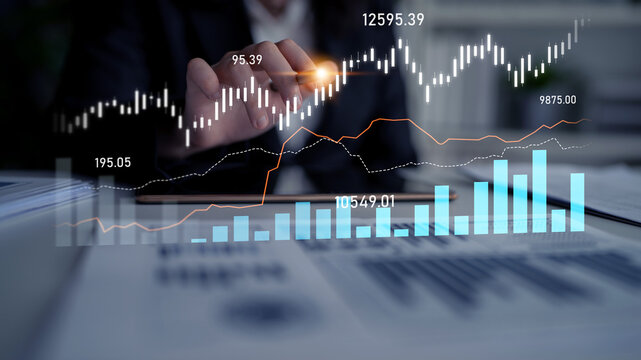 Business professional analyzing financial trends with digital graphs and charts on a computer screen in modern office environment Scalp.