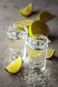 Tequila with salt and lime slices.