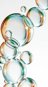 Bubbles float in clear water showing many colors. They shift and move together, creating an interesting visual effect in a bright environment.
