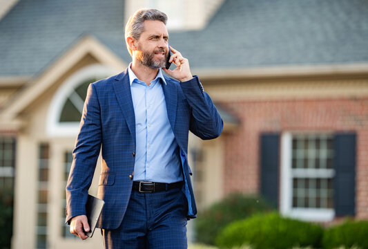 Real estate agent at house for sale. Realtor talking on phone. Rent or buy new home. Home insure. Property insurance promotion. Successful broker. American businessman has phone call, banner