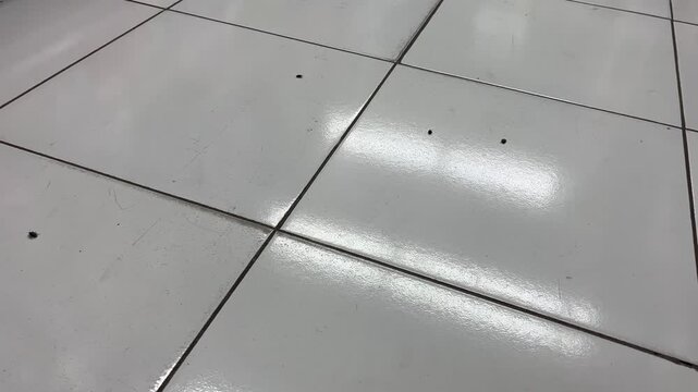 High angle view of clean white ceramic floor tiles background