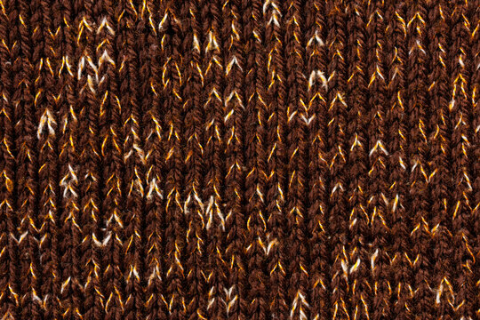 Brown marled knitted fabric texture with speckled wool yarn